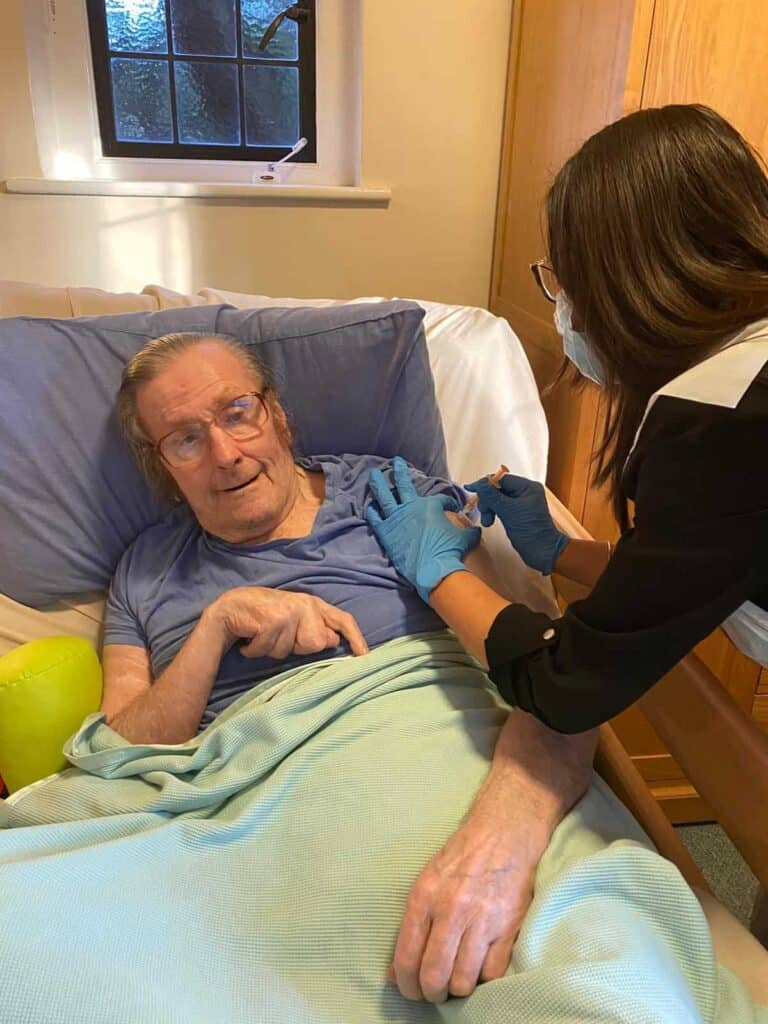 Resident receiving vaccine